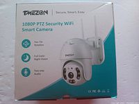 Front box showing TMEZON 1080P PTZ Security WiFi Smart Camera with pan-tilt rotation, full color night vision, two-way audio.