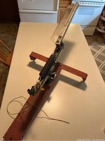 Two angled photos of the trap throwers showing the metal frames, spring launching arms, and wiring arranged on a countertop.