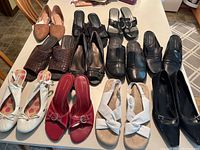 Lot overview showing 10 pairs of assorted women's shoes in various styles and colors.