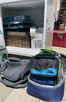 View of two insulated lunch bags, one gray and one blue/green