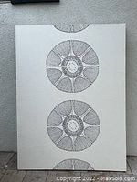 Abstract geometrical wall art piece on white fabric background featuring four circular designs stacked vertically with intricate radial line work.