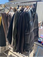 Hanging winter coats and jackets on rack showing various styles and colors