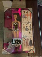 Boxed 35th Anniversary Barbie doll in original packaging with pink reflective interior and '35th Anniversary Barbie' logo.
