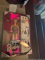 35th Anniversary Barbie doll in original box with display showing doll and packaging.