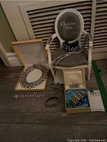Overall view of assorted jewelry on floor and chair stand
