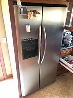 Front view of full unit showing stainless steel exterior and curved door handles