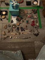 Overview of Tiffany box with assortment of holiday brooches and jewelry