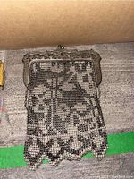 Full view of the vintage metal mesh handbag showing the mesh pattern and scalloped edge.