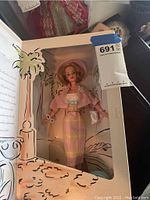 Boxed vintage Barbie doll dressed in pastel plaid outfit with jacket and wide-brimmed hat, in original Spiegel box.