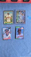 Four individual baseball cards laying flat showing front images and players John Candelaria, Phil Garner, Jeff Sanchez (in case), and Rob Dibble