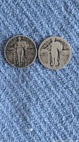 Front view of both 1927 Standing Liberty silver quarters showing Liberty standing with shield and olive branch, date visible.