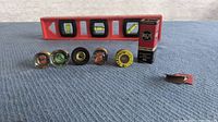 Photo shows the entire fuse lot including five vintage fuses in a row, an RCA fuse box, and a spirit level in the background.