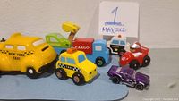 Photo showing a variety of toy cars and a New York Taxi ceramic bank