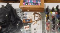 Photo showing a black leather hobo handbag, leather butterfly barrette, wood trinket box, some jewelry including rosaries and crosses, and the Fossil ladies wristwatch.