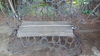 Full view of the horseshoe bench showing wooden seat and horseshoe frame structure