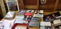 Overview photo showing multiple political books, a 1994 50th anniversary calendar, and buttons featuring famous politicians.