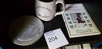 Pewter commemorative plate, ceramic mug, walking tour booklet on table