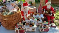 Wide shot of the basket with various Christmas decorations including Santa doll, nutcracker, and miniature ovens.