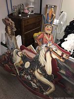 Five vintage Christmas decorations grouped in basement setting showing horse, nutcracker soldier, and Victorian woman figure.