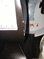 Close up showing minor paint chipping on the metal base of one table lamp.