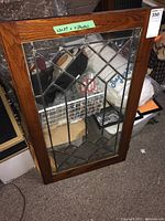 Oak framed door with decorative diamond lattice glass insert with label showing size 23x39.