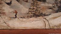 Close-up of the painter's signature 'Davos' and 'D.M. Irwin' on the bottom right, showing part of the painting depicting a skier and a pine tree on a snow-covered hill.