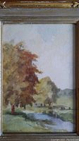 Close-up view of painted scene showing trees, riverbank, and meadow