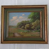 Full view of framed oil painting showing landscape and signature with visible frame paint chipping