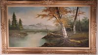 Full view of large framed oil painting depicting a lake, birch trees, and mountains under a cloudy sky.