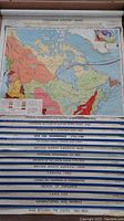 Photo showing entire series of 15 maps with titles and parts of maps visible mounted on a wall mount.