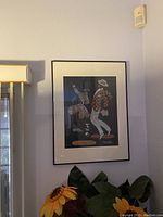 Photo of framed Brazilian-leather cut artwork depicting two stylized dancing figures with detailed leather patterns