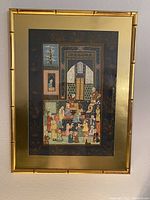 Full view of the framed oriental silk embroidery hanging with bamboo-style frame and detailed colorful embroidery inside.