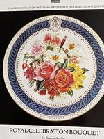 Front view of the commemorative plate showing floral bouquet, crest, and gold edging