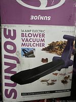 Box showing SunJoe branding and model information for 14-amp electric blower vacuum mulcher with gutter cleaning tubes.