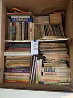 Full view of two shelves filled with various books on religion, science, medicine, nutrition, and related health topics.