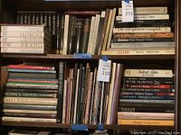 First photo showing a shelf of books including titles on art museums and dance.