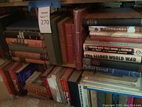 Photo of assorted books stacked on shelves, showing various titles related to history and politics.