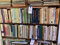 Photo of upper two shelves showing books on nutrition, medicine, and gardening titles in a bookshelf.