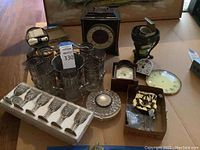 Overview of clocks, ethanol glasses, ice bucket, and loose clock parts on floor