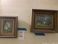 Photo showing both framed art pieces hanging on wall, each approximately 12x10 inches