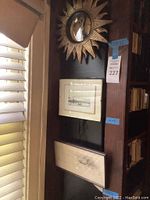 Full view of the lot hanging vertically showing sun mirror at top and two framed art pieces below