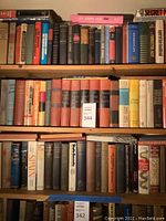 Wide view of multiple shelves filled with hardcover books, many focused on historical and political topics.