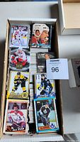 View of a box with assorted hockey cards, showing various player images and card designs.