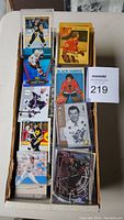 Top view of hockey cards in protective sleeves and regular cards in box.