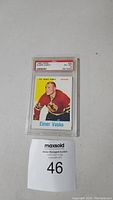 Front side of 1960 Topps #23 Elmer Vasko hockey card, showing the player in Chicago Black Hawks uniform with PSA grading label on top.
