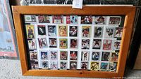 Framed display with all 43 hockey cards arranged in rows within a wooden frame under glass.