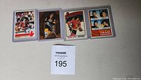 Four hockey cards laid flat showing Bobby Orr and Bruins team leaders