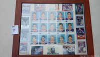 Front view of framed uncut Edmonton Oilers hockey card sheet showing the player images in a grid layout, including Wayne Gretzky and others.