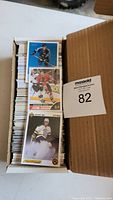 View of box full of hockey trading cards showing top cards including Boston Bruins players in vintage and modern designs