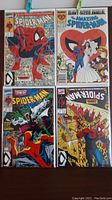 Four vintage Marvel Spider-Man comic books arranged in two rows showing front covers.